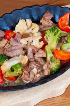 meat with vegetables at frying pan