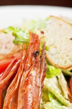 Tasty shrimp salad with vegetables on christmas table