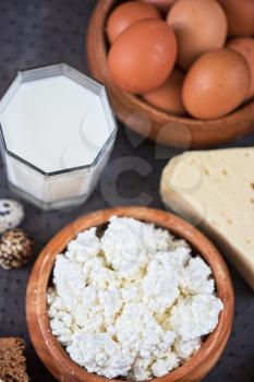 still life with dairy products as milk, cheese cottage cheese eggs and bread 