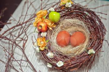 eggs in nest on a wooden background for easter