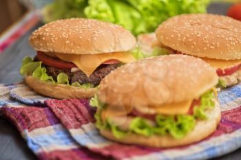 Closeup of home made burgers on wooden table