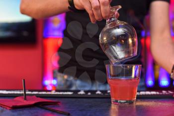 Closeup photo in a bar where barmen makes cocktail