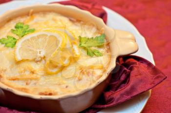 Delicious fish stew dish closeup. At russian dishes - skoblyanka.