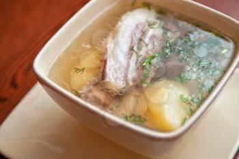cooked soup with lamb meat, potatoes and vegetables 
