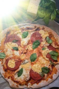 rustic italian pizza with mozzarella cheese tomato and basil leaves