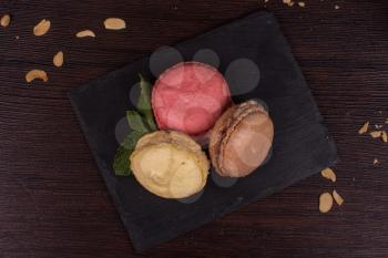Colorful french macarons on wooden background