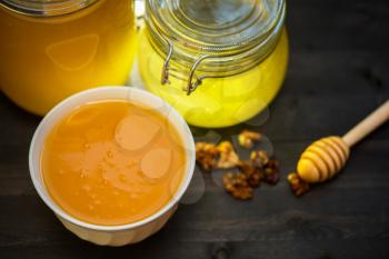 Honey with walnut on wooden background