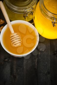 Honey with walnut on wooden background