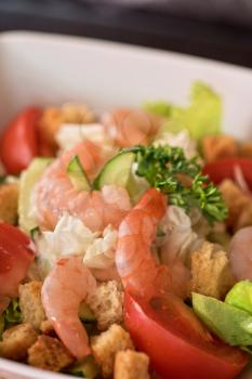 Caesar shrimp salad with cheese and arugula