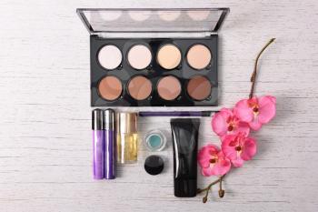 cosmetics set for make-up on wood background