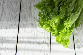 lettuce salad on a white wood background
