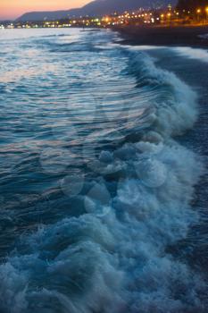 Defocused background of blue sea with waves in the evening