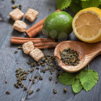 tea composition with cinnamon sticks, lemons