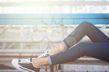 closeup of woman legs in white gumshoes, outdoor shot