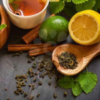 tea composition with cinnamon sticks, lemons