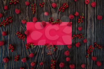 Fresh berries raspberry and red currant on wooden table, background for design