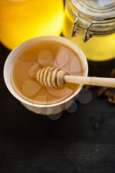 Honey with walnut on wooden background