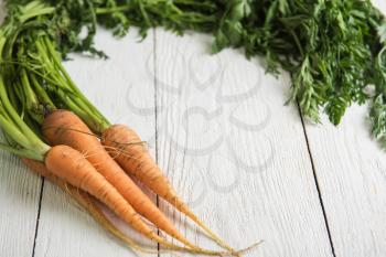 Freshly grown carrots on wooden table