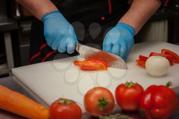 Chef cutting vegetables with knife