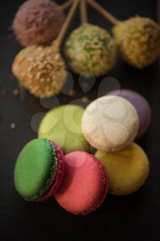 French colorful macarons on black background