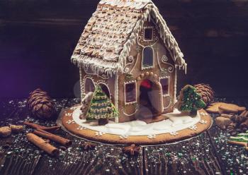 Homemade gingerbread house on dark background, xmas theme