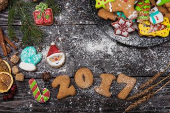 Gingerbreads for new years and christmas on wooden background, xmas theme