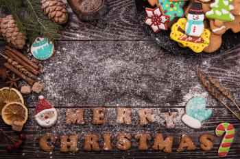 Gingerbreads and coffee for new years and christmas on wooden background, xmas theme