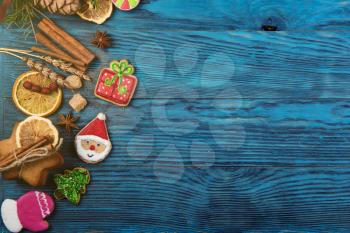 Different ginger cookies for new years and christmas on wooden background, top view with space for design