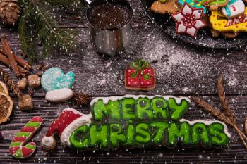 Different ginger cookies and coffee for new years and christmas on wooden background, xmas theme. Top view.