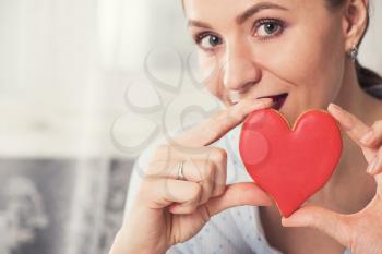 Young woman with gingerbread heart cookies. Illustrate of Happy Valentines Day or Mother day.