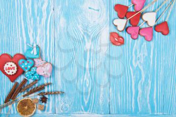 Gingerbreads for Valentines Day or wedding theme on blue wooden background