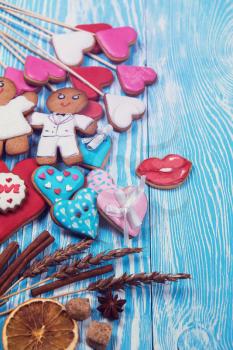 Gingerbreads for Valentines Day or wedding theme on blue wooden background