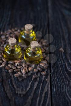 Oil of cedar nuts on a dark wooden background