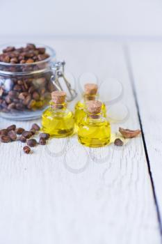 Oil of cedar nuts on a white wooden background