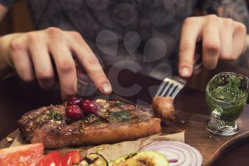 grilled beef steak with sauce and vegetables