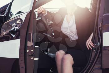 Woman in business suit in a car
