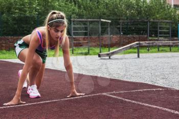 A young beauty athletic woman in sportswear ready for running at outdoor.