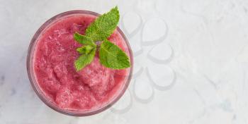 Strawberry smoothie with mint on a white concrete background