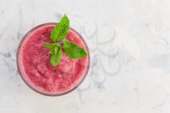 Strawberry smoothie with mint on a white concrete background