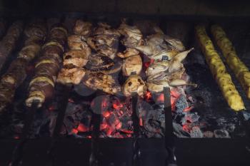 Grilling marinated shashlik on a grill