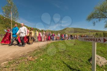 TOPOLNOE, ALTAY, RUSSIA - May 27, 2018: Folk festivities dedicated to the feast of the Holy Trinity. Ancient Russian rite: procession with a birch for its further sinking.