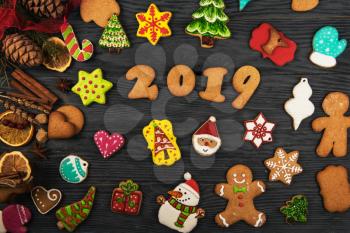 Gingerbreads for new 2019 year holiday on wooden background, xmas theme