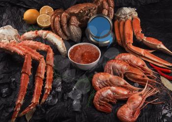 Set of seafood: red and black caviar, limb of hairy crab, limb of snow crab, far eastern kamchatka crab