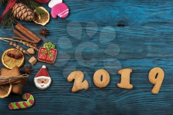 Gingerbreads cookies for new 2019 year on wooden background, xmas theme