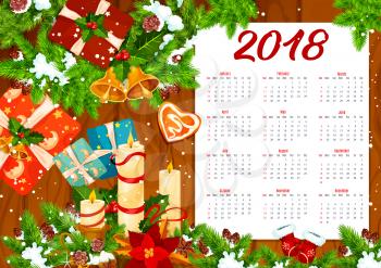 Calendar template with Christmas wreath on wooden background. 2018 New Year calendar with winter holiday gift, Santa bell and holly berry garland, candle, snowflake, cookie and ribbon bow