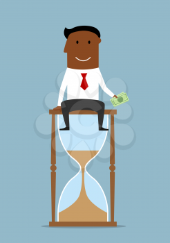 Time is money business concept. Cheerful accomplished businessman sitting on the top of hourglass and holding dollar bills in hand 