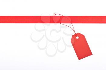 Royalty Free Photo of a Red Ribbon With a Tag