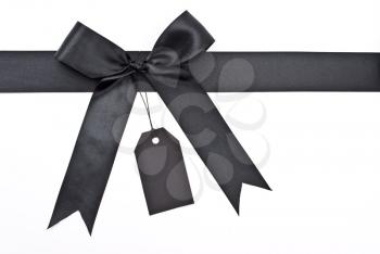 Royalty Free Photo of a Black Bow With Label