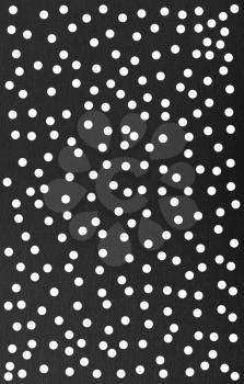 Abstract background of black paper with white dots
