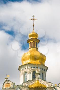 Kiev-Pecherskaya Laura. Church with Golden dome and blue sky with clouds